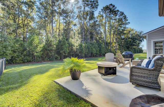 view of yard with an outdoor fire pit and a patio area