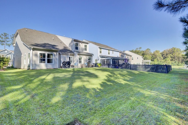 rear view of house featuring a lawn