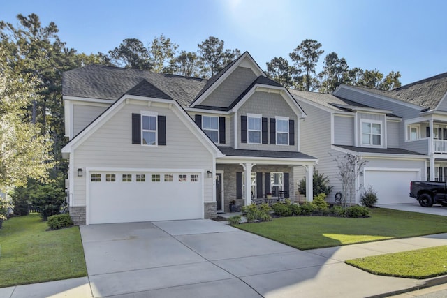 view of front of property featuring a front lawn, a porch, and a garage