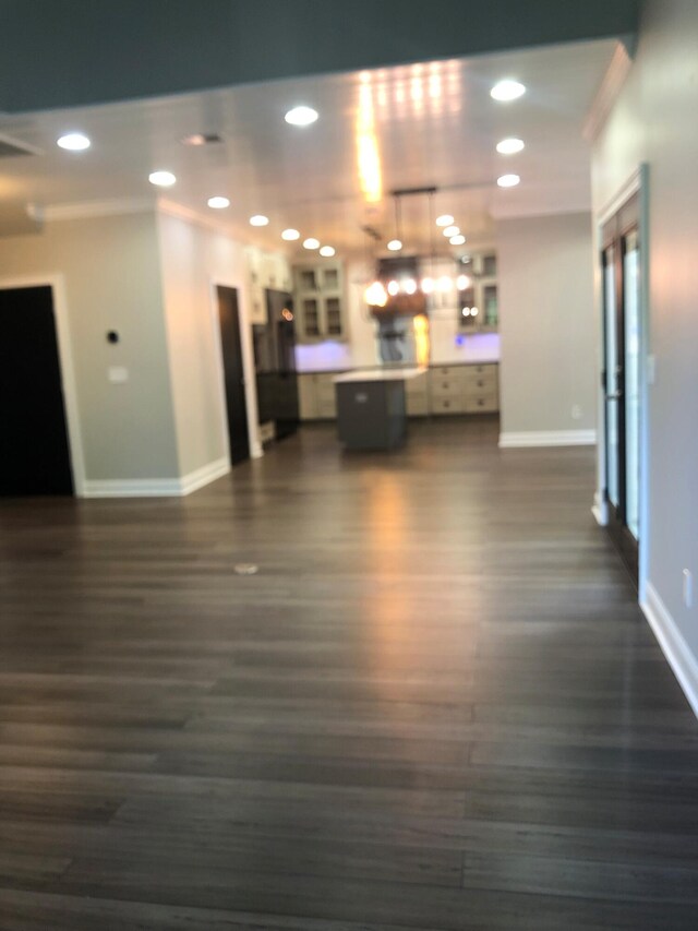 interior space featuring crown molding, baseboards, and recessed lighting