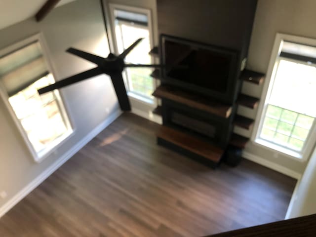 living room featuring baseboards and dark wood-style flooring
