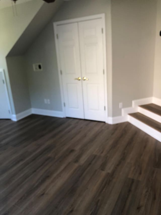 bonus room with a ceiling fan, baseboards, vaulted ceiling, and dark wood finished floors