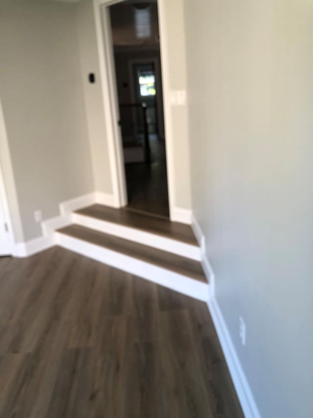 hall with wood finished floors and baseboards