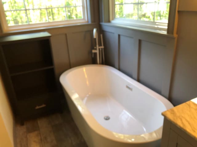 bathroom with a freestanding tub and a wealth of natural light