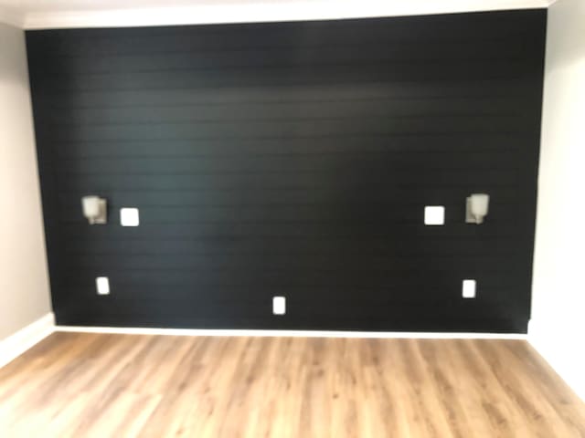 unfurnished room featuring light wood-style flooring and baseboards