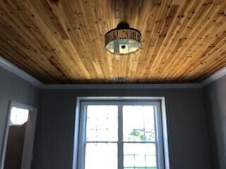 details featuring wood ceiling and ornamental molding