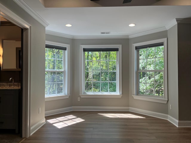 unfurnished dining area with wood finished floors, baseboards, and a healthy amount of sunlight