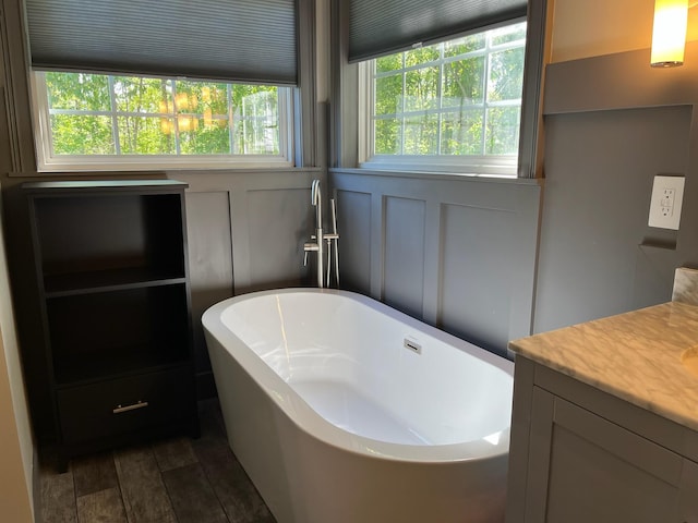 full bath with a freestanding bath and vanity