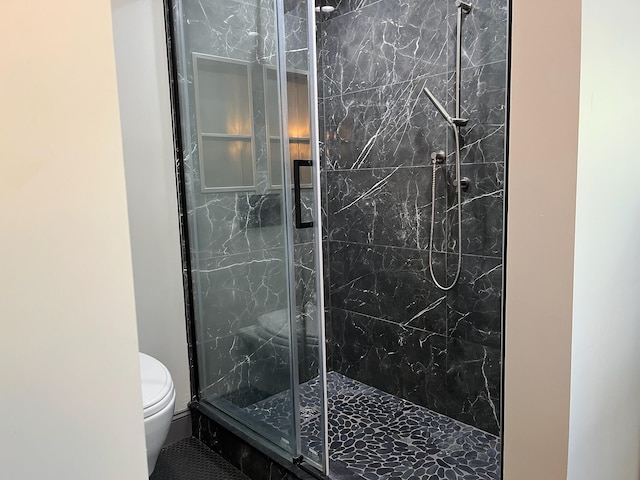 bathroom with toilet and a marble finish shower