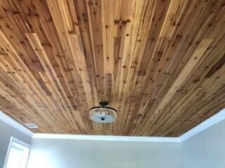 room details featuring wooden ceiling and crown molding