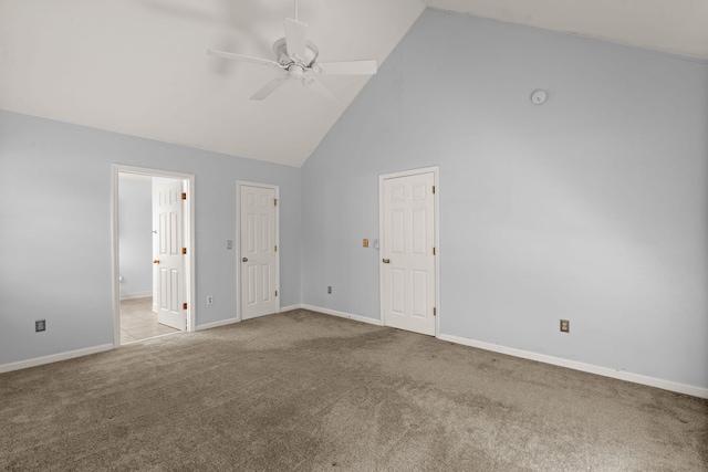 unfurnished bedroom with carpet floors, connected bathroom, baseboards, and high vaulted ceiling