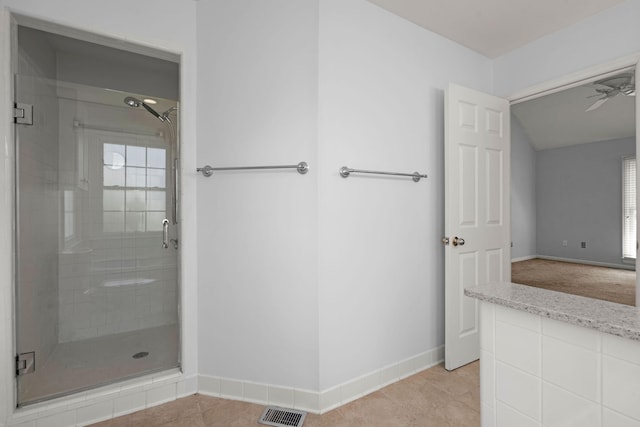 bathroom featuring visible vents, tile patterned flooring, baseboards, a ceiling fan, and a stall shower