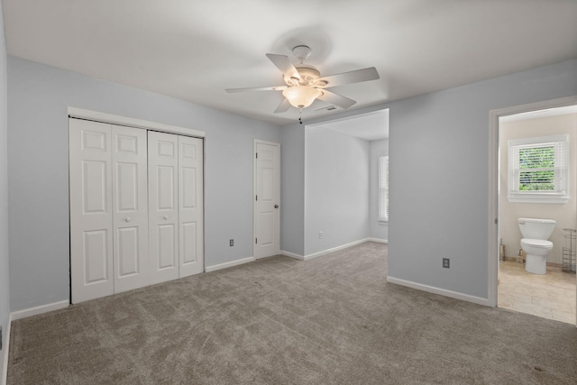 unfurnished bedroom featuring baseboards, multiple windows, carpet, and a closet