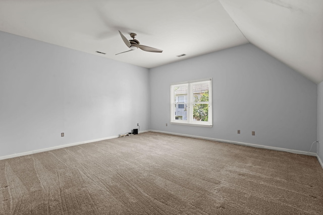 interior space with a ceiling fan, carpet, and vaulted ceiling
