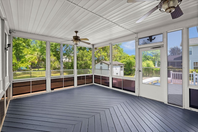 unfurnished sunroom with ceiling fan and plenty of natural light