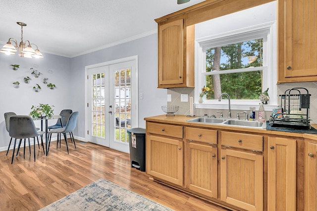 kitchen featuring a wealth of natural light, sink, and crown molding