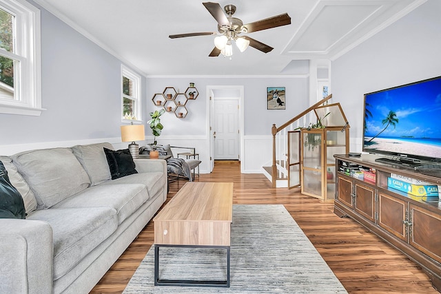 living room with a wealth of natural light, wood-type flooring, and crown molding