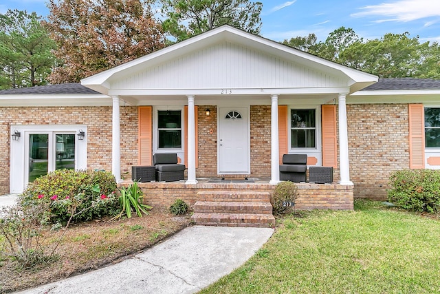 view of front of home with a porch and a front lawn