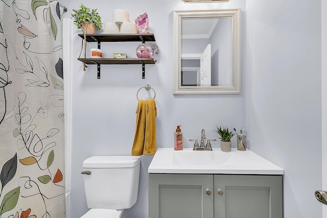 bathroom featuring toilet, vanity, curtained shower, and crown molding