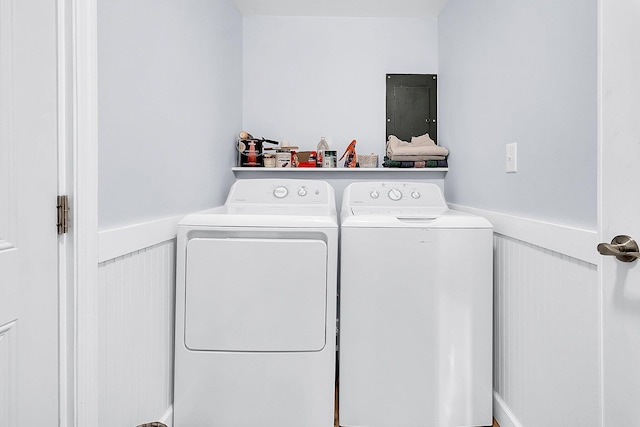 washroom with electric panel and separate washer and dryer