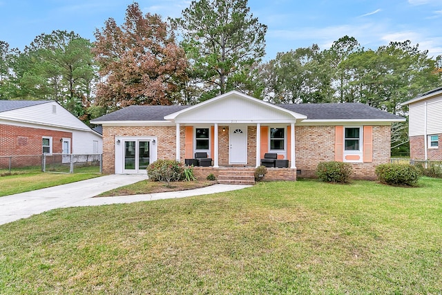 ranch-style house with a front yard and covered porch