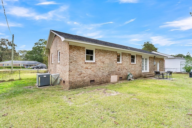 rear view of house with a yard