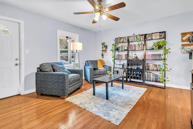 living room featuring wood-type flooring and ceiling fan