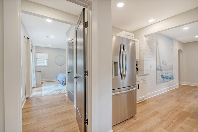 hall featuring a barn door and light hardwood / wood-style floors