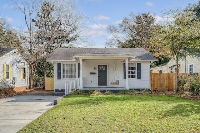 bungalow-style house with a front yard and covered porch