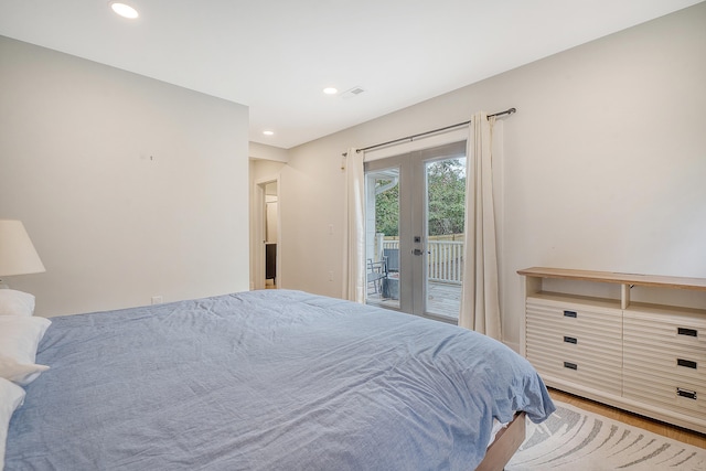 bedroom featuring wood-type flooring, access to exterior, and french doors