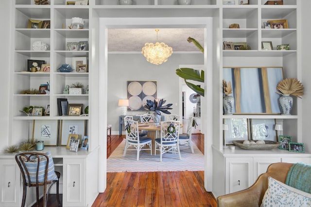 interior space featuring hardwood / wood-style floors and a notable chandelier