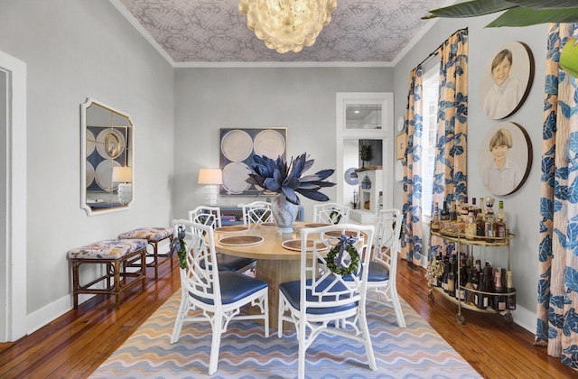 dining space with hardwood / wood-style floors and ornamental molding