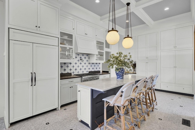 kitchen featuring white cabinetry, paneled built in refrigerator, pendant lighting, and custom exhaust hood