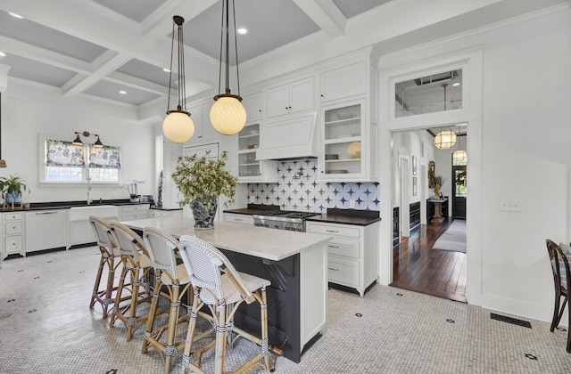 kitchen featuring dishwasher, a center island, white cabinetry, and hanging light fixtures