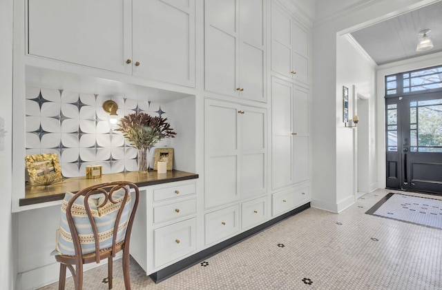 mudroom featuring crown molding and light tile patterned flooring