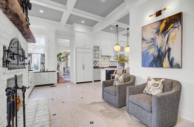 living room featuring beam ceiling, ornamental molding, and coffered ceiling