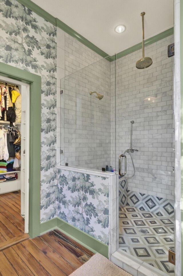 bathroom featuring hardwood / wood-style flooring and an enclosed shower