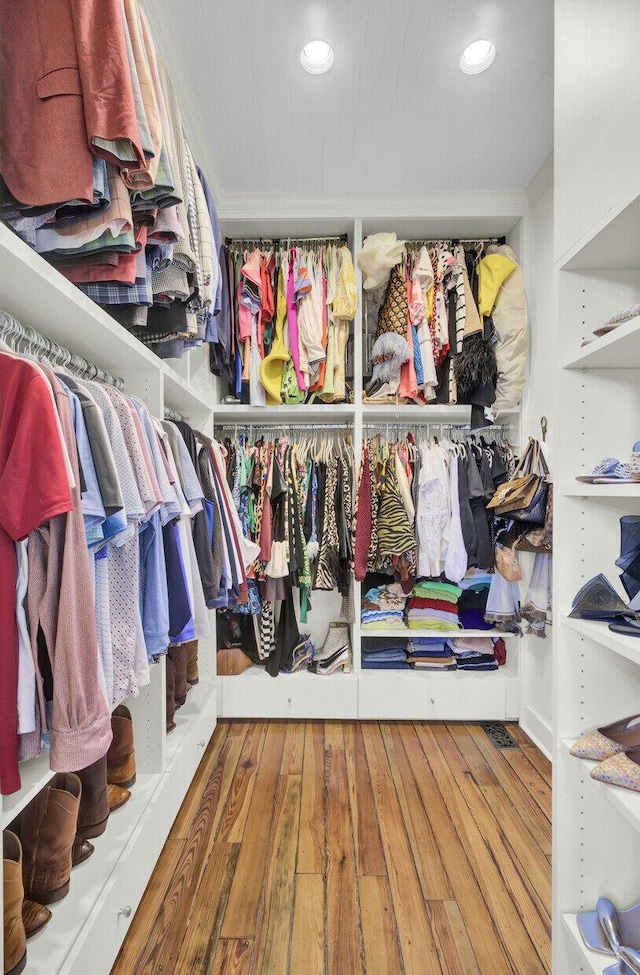 spacious closet with hardwood / wood-style flooring