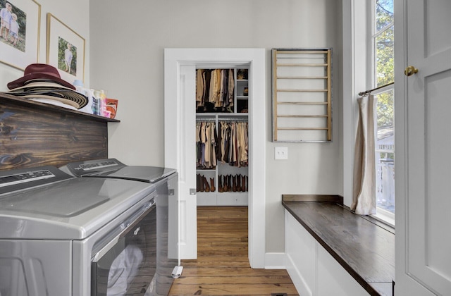 laundry area with hardwood / wood-style flooring and independent washer and dryer