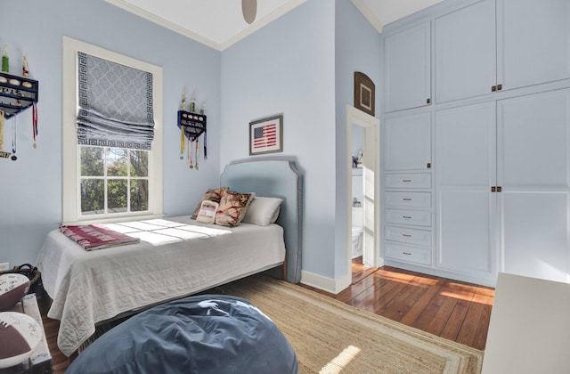 bedroom with ceiling fan, hardwood / wood-style floors, and ornamental molding