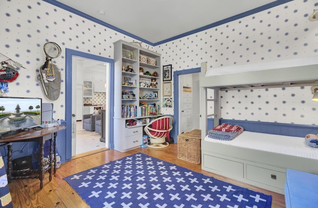 bedroom featuring crown molding and wood-type flooring