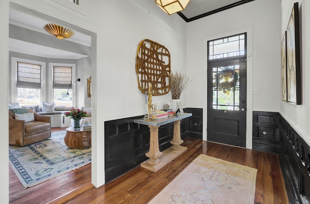 entryway featuring dark hardwood / wood-style flooring and ornamental molding