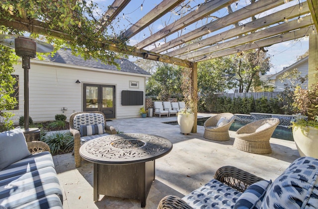 view of patio with a pergola, french doors, and an outdoor living space with a fire pit