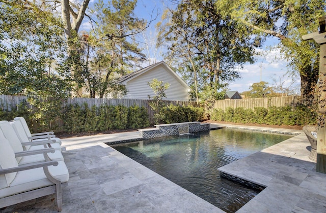 view of swimming pool with pool water feature and a patio area