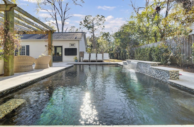 view of pool with pool water feature, a patio area, and a pergola