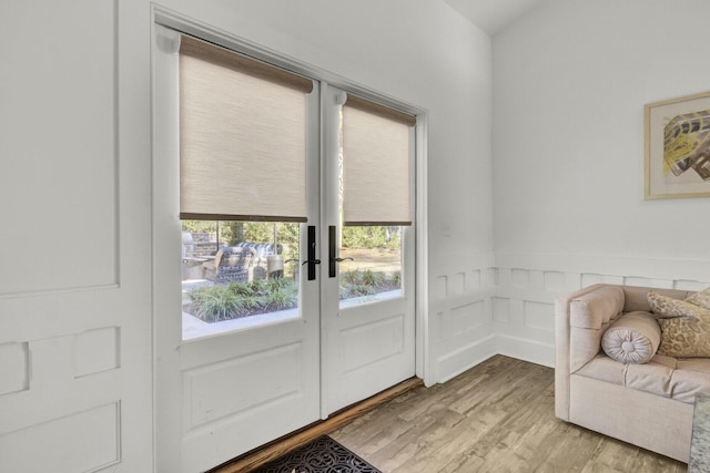 doorway to outside featuring french doors and light hardwood / wood-style floors