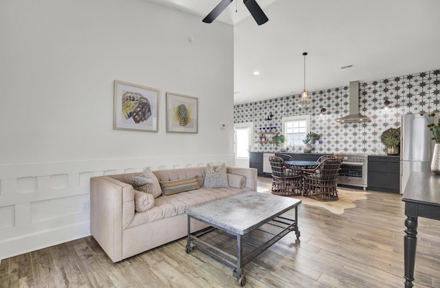 living room featuring ceiling fan and light wood-type flooring