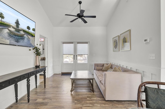 living room with hardwood / wood-style flooring, ceiling fan, lofted ceiling, and french doors