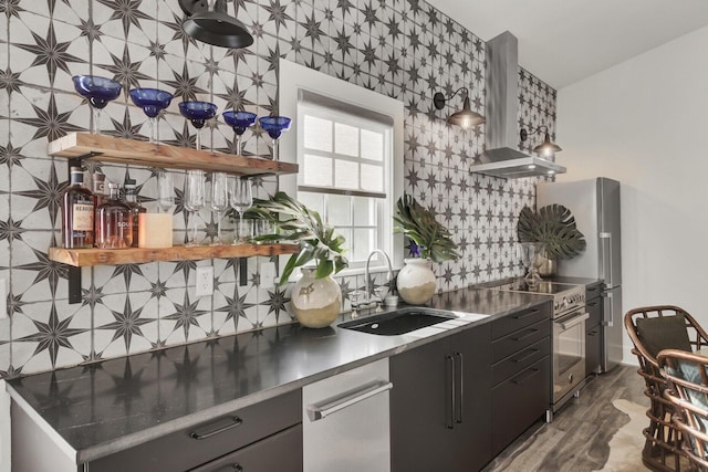 kitchen featuring backsplash, wall chimney exhaust hood, sink, dark hardwood / wood-style floors, and stainless steel range with electric cooktop