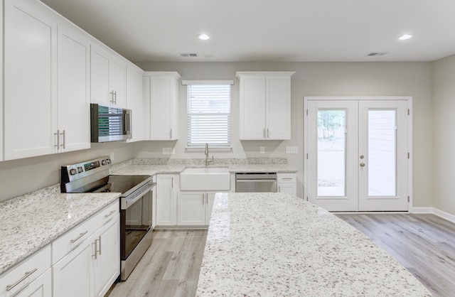 277 W Smith St, Lincolnville, SC 29485 - kitchen with stainless steel appliances, a sink, french doors, light wood finished floors, and recessed lighting